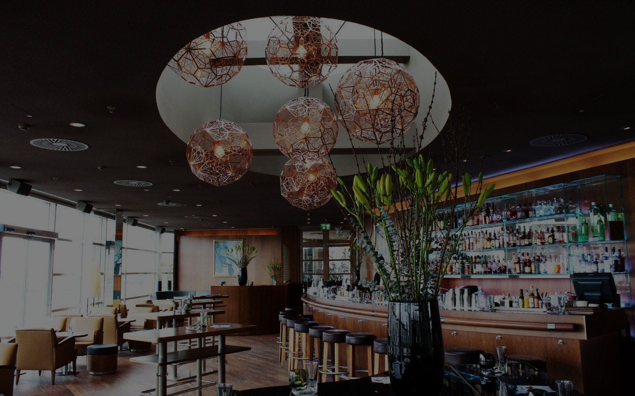 Interior of Sky Bar Vienna with modern cocktail bar, lounge atmosphere and designer lighting